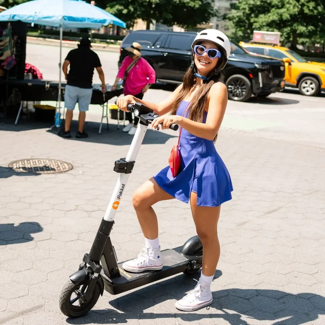 Rider with a Ride by iPakket e-scooter at a street market in New York City